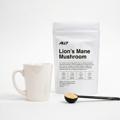 ALL7 Lion's Mane Mushroom powder with the ALL7 black measuring spoon and a mug